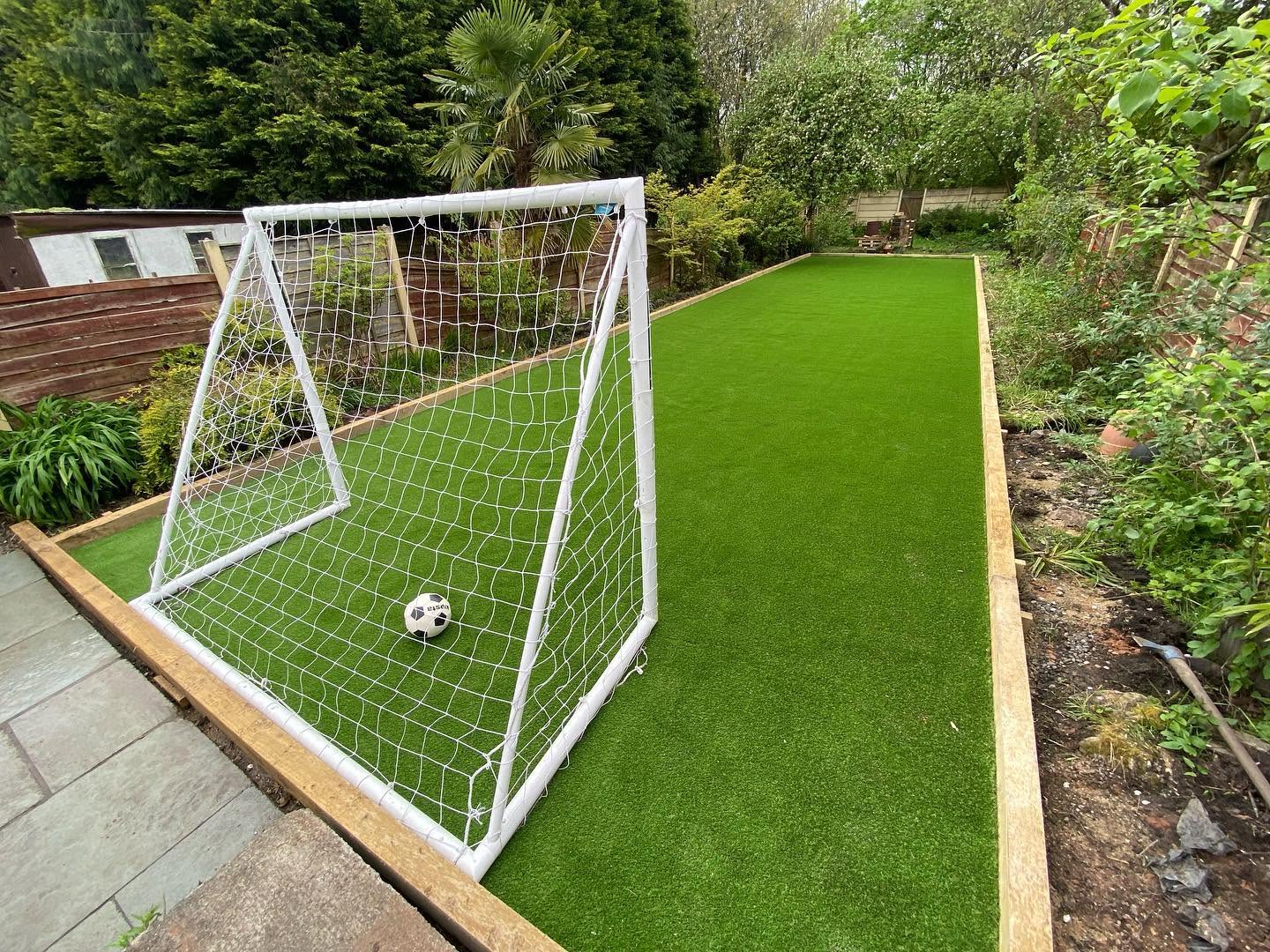 The same garden finished with artificial grass and a football play area