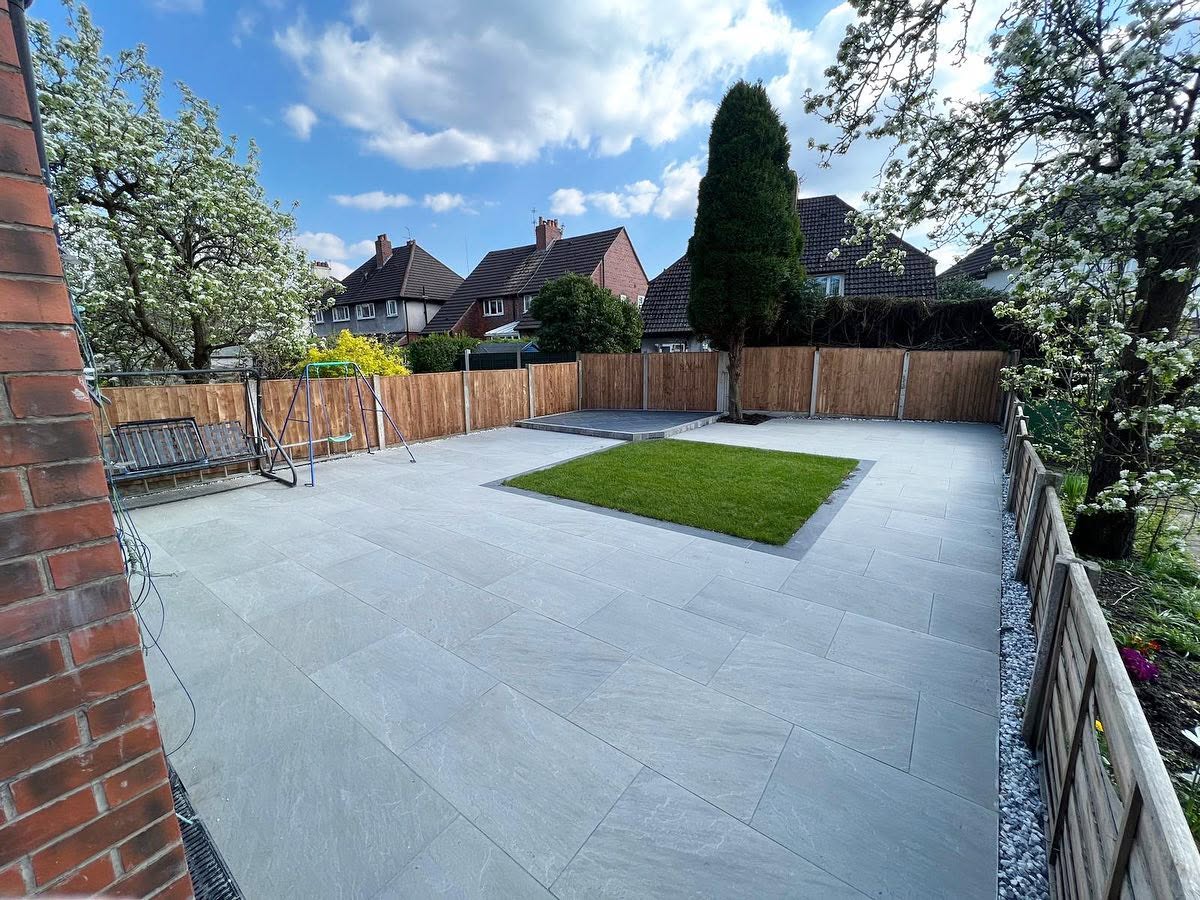 The same garden finished with a light-grey porcelain patio and a central lawn